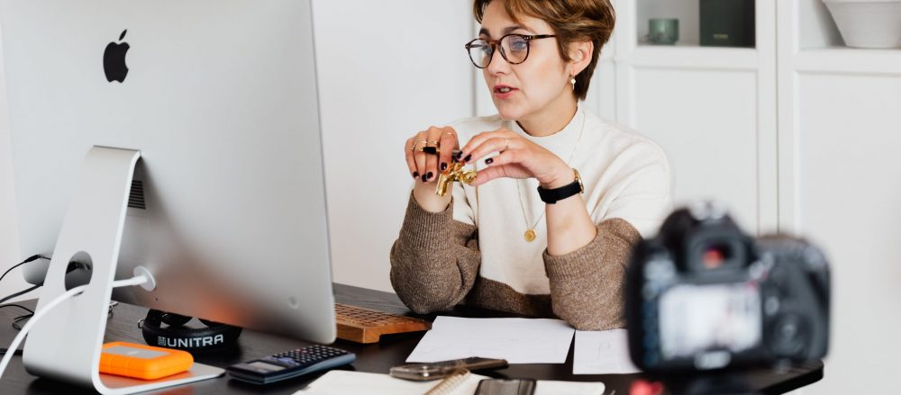 A woman at a computer teaching a course