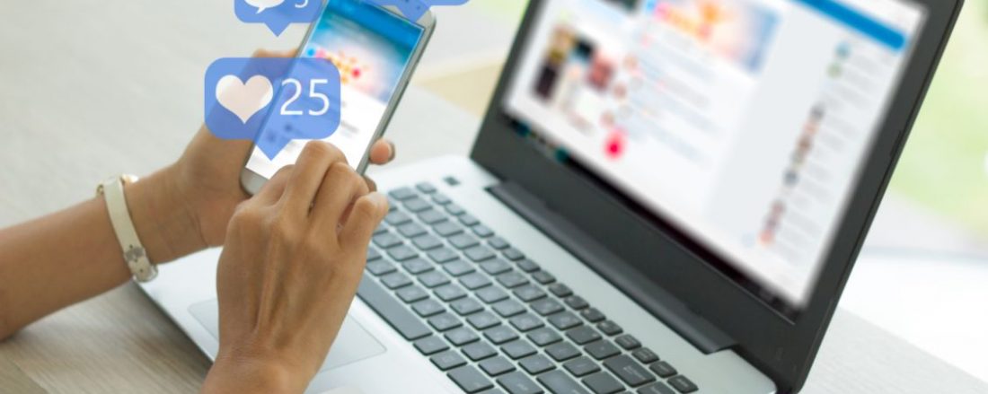 A person sitting at a laptop using social media.