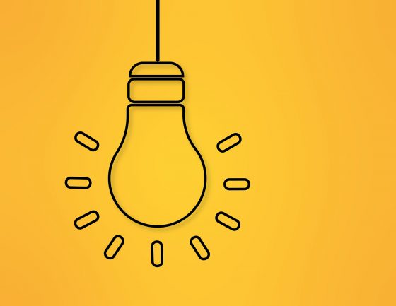 Stylistic lineart of a glowing lightbulb on a cheery yellow background