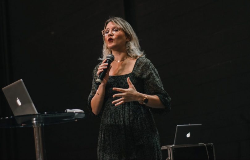 Woman giving a speech on stage