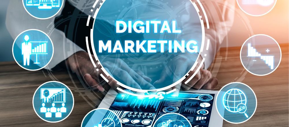 The words "Digital Marketing" and related images over a photo of a person holding a tablet.